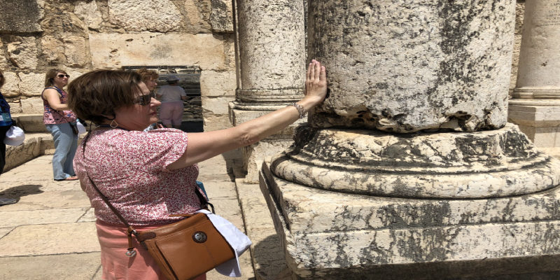 Barbara touching column from synagogue that Jesus taught (1)